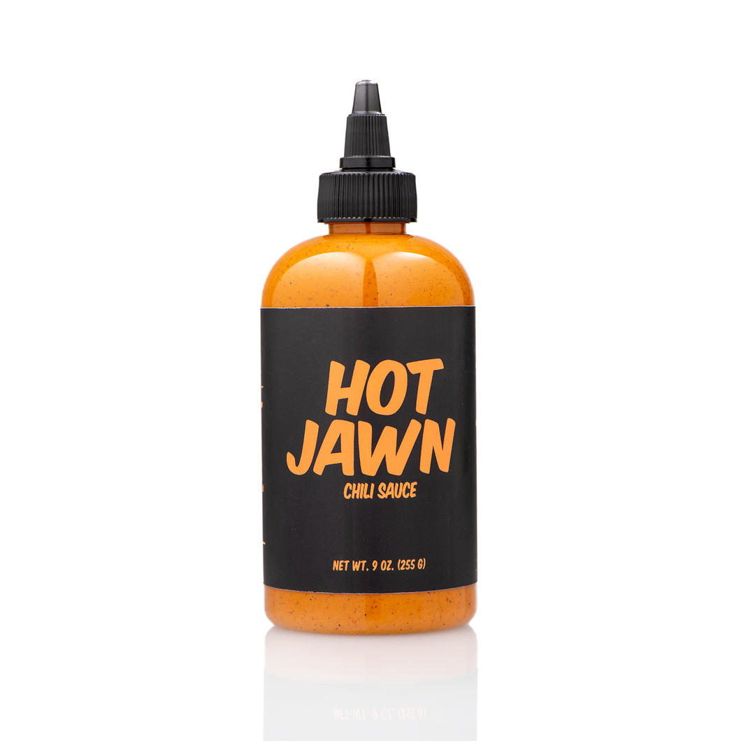 A single bottle of Hot Jawn Chili Sauce on a white background 